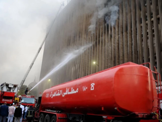 firefighters douse the flames after a fire broke out in the telephones landline exchanging station and ministry of communications building in cairo on july 7 photo afp