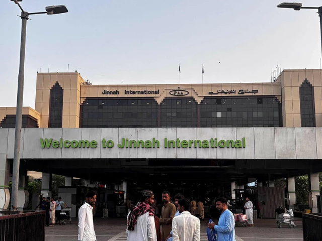 passengers wait outside at jinnah international airport after all domestic and international flights were cancelled in karachi on may 7 2025 afp