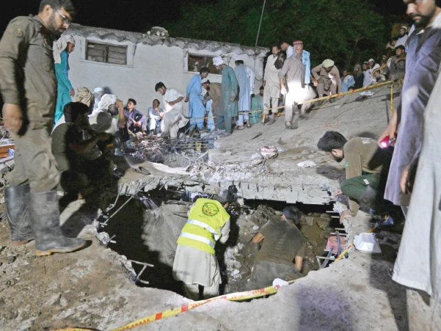 rescue workers and residents search for victims in the debris of a collapsed house after a cloudburst in dolari village of swabi district photo afp