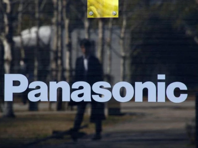 a man is reflected on panasonic corp s logo at panasonic center in tokyo japan source reuters