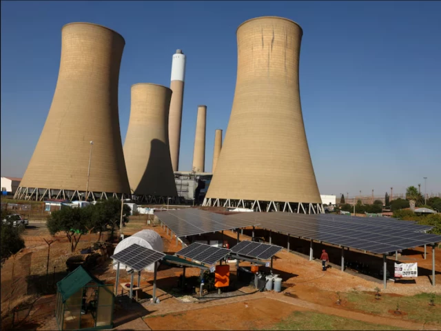 solar panels are seen near the cooling towers of a retired coal fired komati power station operated by eskom near komati village in the mpumalanga province in south africa source reuters