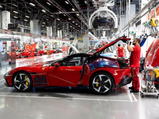 a ferrari worker inspects a car inside the company s factory in maranello italy source reuters