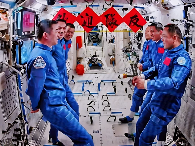 this image captured at beijing aerospace control center on nov 1 2025 shows the crew of shenzhou 20 and shenzhou 21 spaceships talking with each other photo xinhua