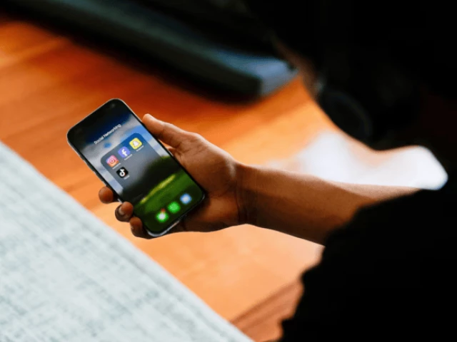 a high school student poses with his mobile phone showing his social media applications in melbourne australia november 28 2024 source reuters
