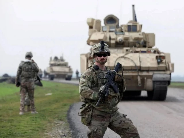 a soldier from the us led coalition stands guard during a joint us  kurdish led syrian democratic forces sdf patrol in the countryside of qamishli in northeastern syria february 8 2024 photo reuters
