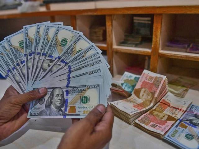 a foreign currency dealer counts us dollars at a shop in karachi pakistan on may 19 2022 photo afp file