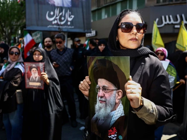 a woman holds a picture of late supreme leader of iran ayatollah ali khamenei during a ceremony in tehran iran 9 april 2026 photo reuters