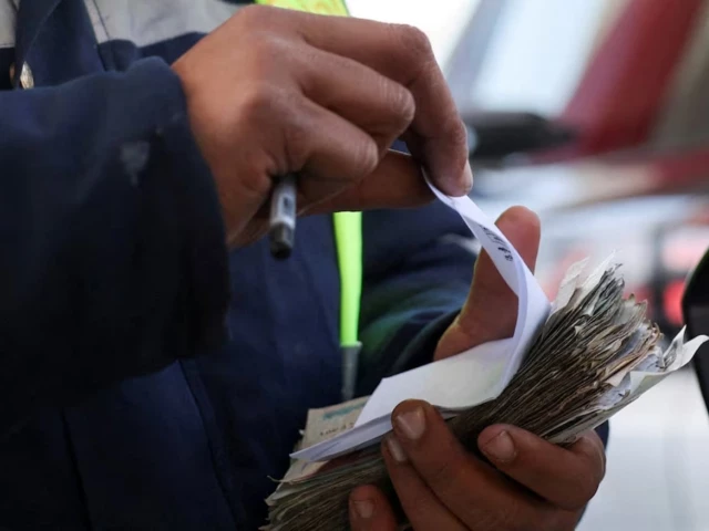 a worker counts egyptian pounds and issues a receipt after filling a car s tank at a chillout petrol station as egypt raises domestic fuel prices by up to 17 amid global energy turmoil and the expanding us israeli conflict with iran in cairo egypt march 10 2026 photo reuters