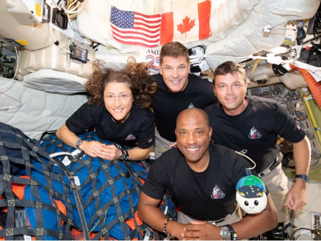 the nasa artemis ii crew mission specialist christina koch mission specialist jeremy hansen commander reid wiseman and pilot victor glover pose for a group photo inside the orion spacecraft on their way home following a flyby of the far side of the moon on april 6 2026 photo reuters