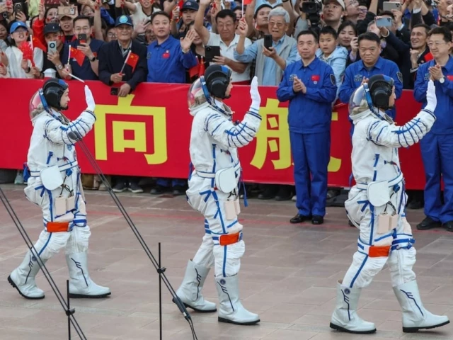 astronauts zhu yangzhu zhang zhiyuan and lai ka ying who is the first astronaut from hong kong wave during a see off ceremony before taking part in the shenzhou 23 spaceflight mission to china s tiangong space station at jiuquan satellite launch center near jiuquan gansu province china may 24 2026 reuters