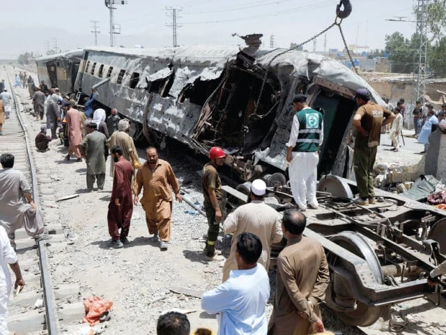 railway workers remove the wreckage of a train damaged in a suicide attack in quetta photo reuters