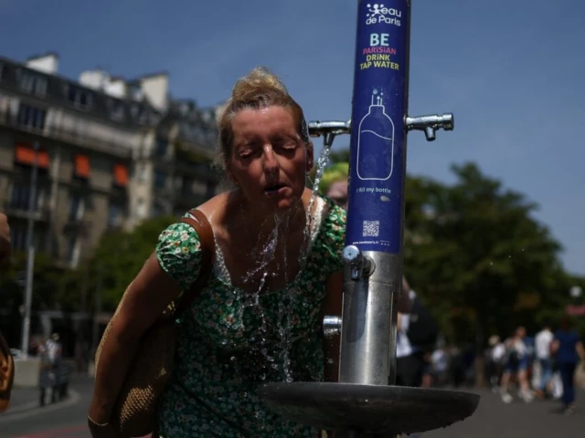 a woman cools off in a public fountain near the place du trocadero during high temperatures amid a heatwave in paris france on june 27 2026 photo reuters