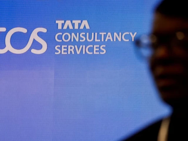 a man walks past a logo of tata consultancy services tcs before a press conference announcing the company s quarterly results in mumbai india january 11 2024 reuters