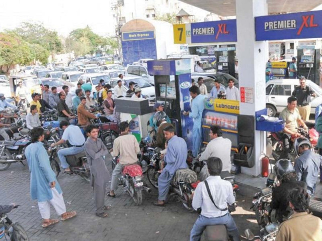 people wait in line at a petrol pump file photo